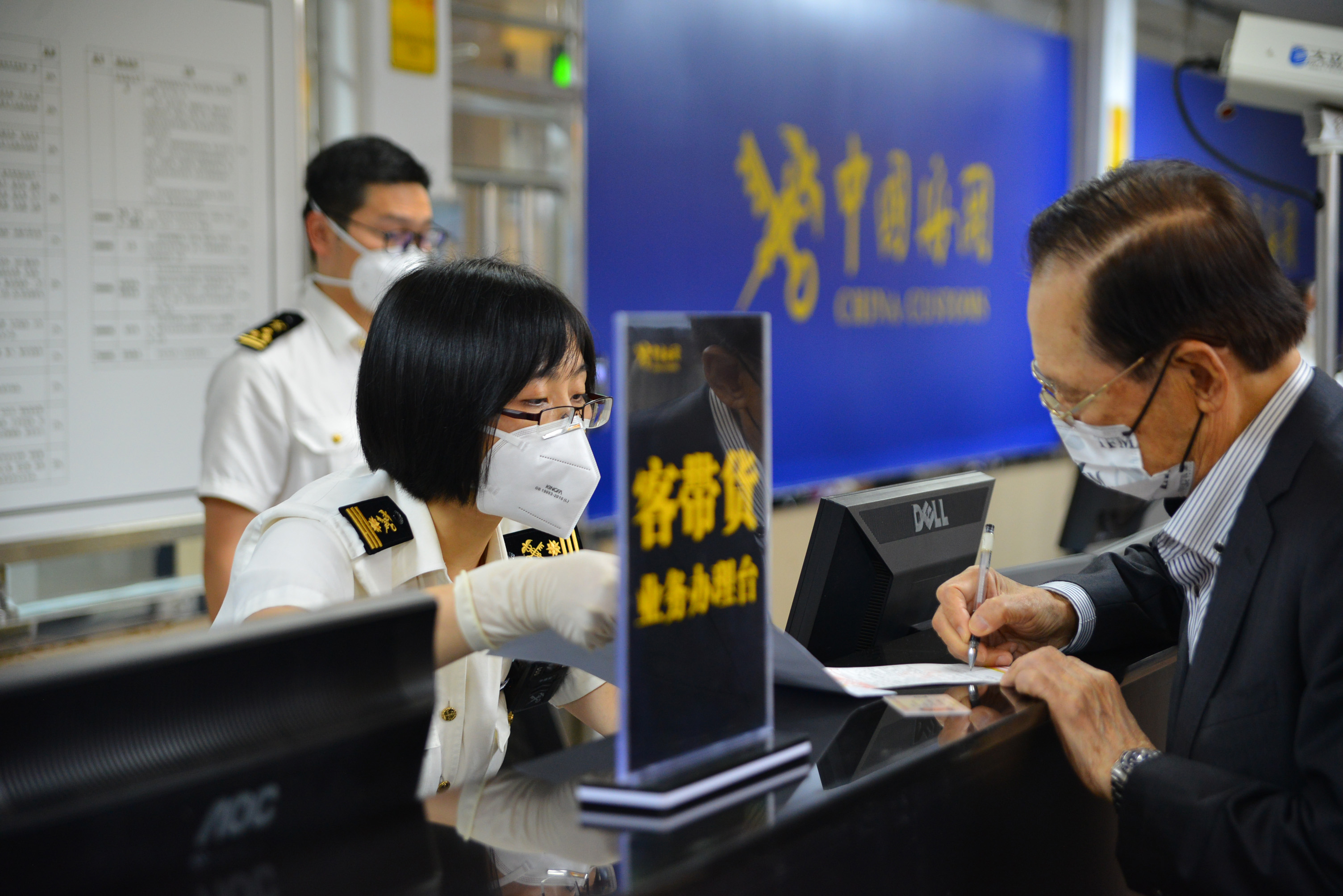 太平海关旅检口岸关员指导旅客办理“客带货”业务手续 陈劭邦摄